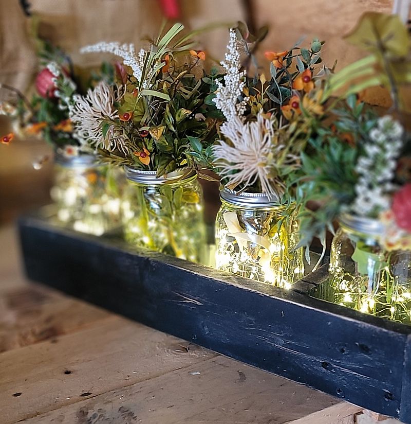 light up glass jars with greenery