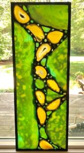 green and yellow stained glass window hanging